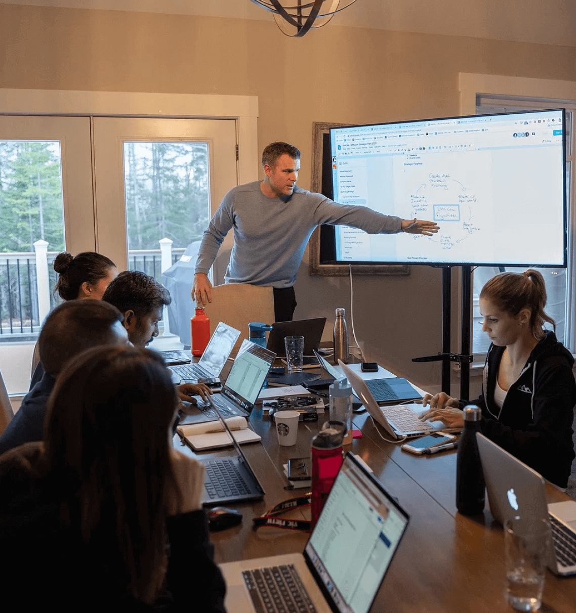 A man presenting to a small group around a conference table